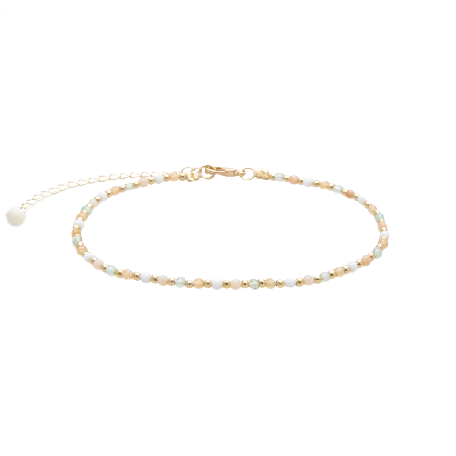 The Anklet Chapter: Spring 2026’s Quiet Return of the Layered Ankle-Bracelet Stack — Tiny Stone Beads, Crystal Talismans, and Healing Charms Knotted Onto Soft Cord at the Bare Skin Above a Sandalled Foot Until Every Step Hums Like a Tide-Pool Drifting Across Sun-Warmed Sand at the Honey-Gold Hour of a Pacific-Coast Afternoon